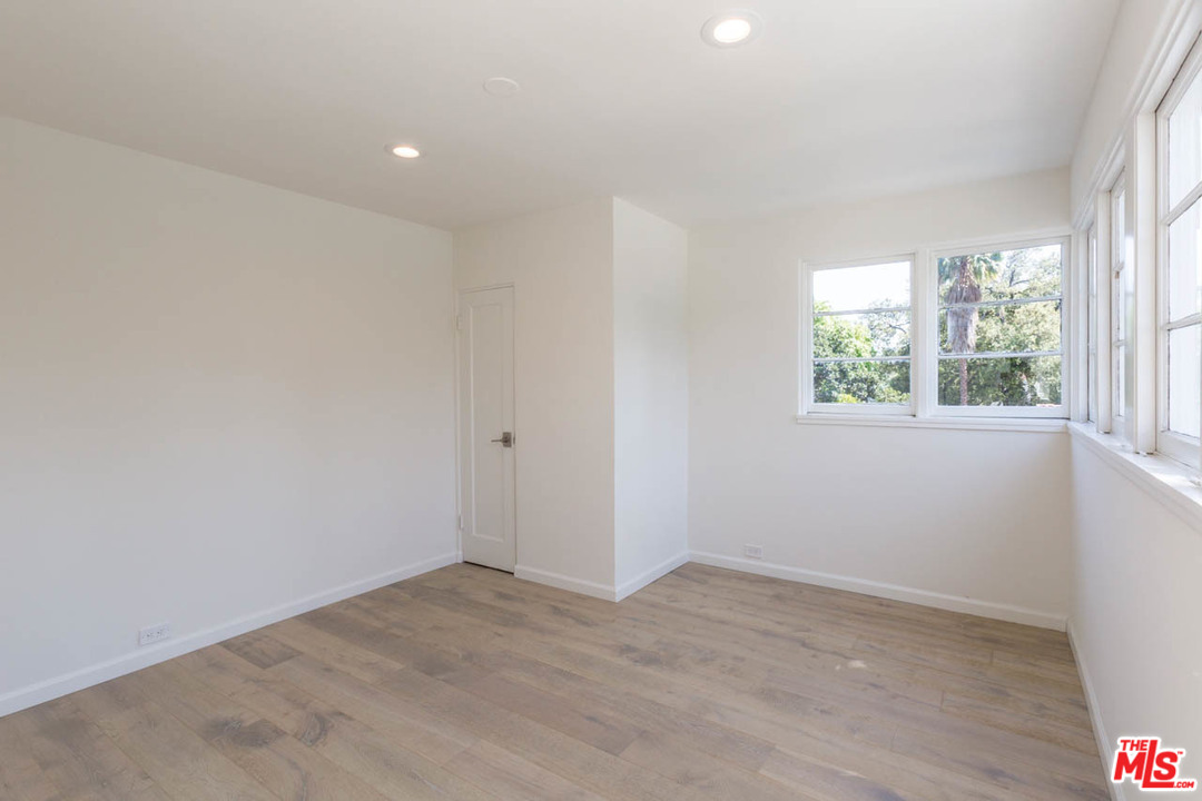 5 Richland Place Pasadena, CA 91103 - Photo 45 of 54 an empty room with wooden floor and windows
