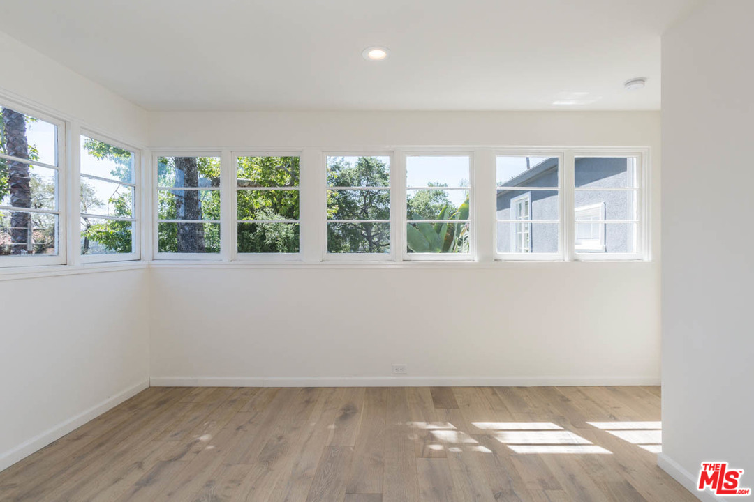 5 Richland Place Pasadena, CA 91103 - Photo 46 of 54 an empty room with wooden floor and windows