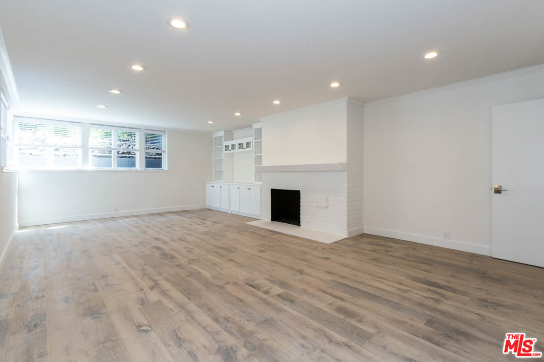 5 Richland Place Pasadena, CA 91103 - Photo 47 of 54 an empty room with wooden floor and fireplace