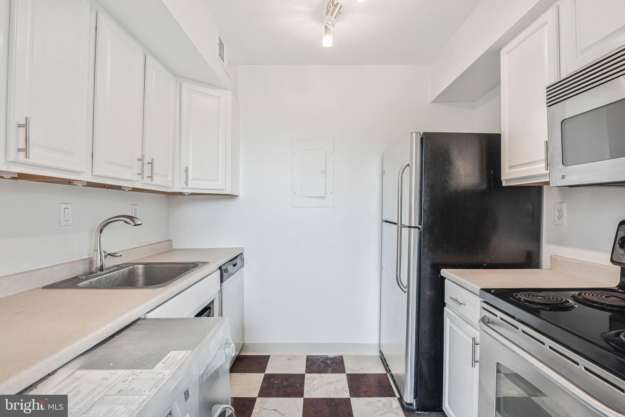 80 New York Avenue Northwest, Unit 303 Washington, DC 20001 - Photo 19 of 27 a kitchen with a sink stove and refrigerator