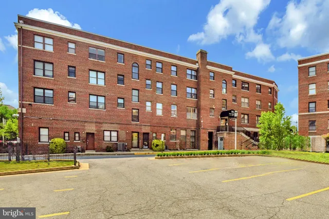 a front view of a building with a garden