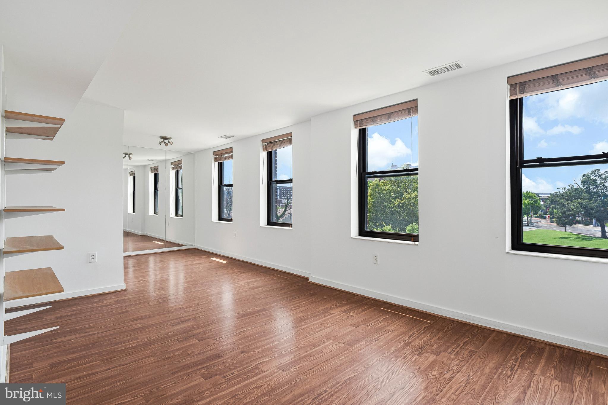 80 New York Avenue Northwest, Unit 303 Washington, DC 20001 - Photo 10 of 27 a view of an empty room with wooden floor and a window
