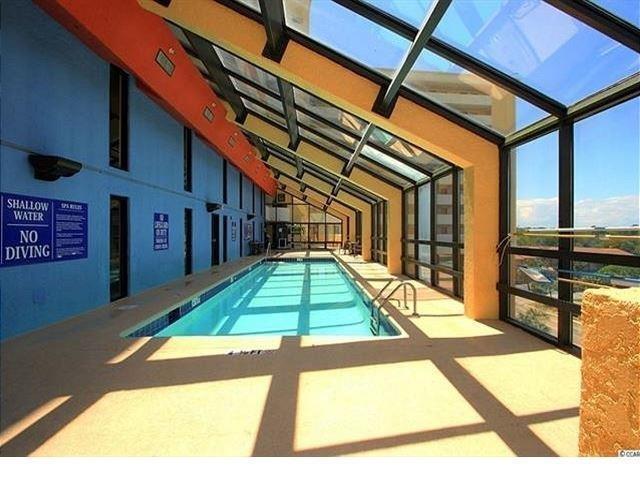 6900 North Ocean Boulevard, Unit 611 Myrtle Beach, SC 29572 - Photo 14 of 17 Community pool featuring a sunroom