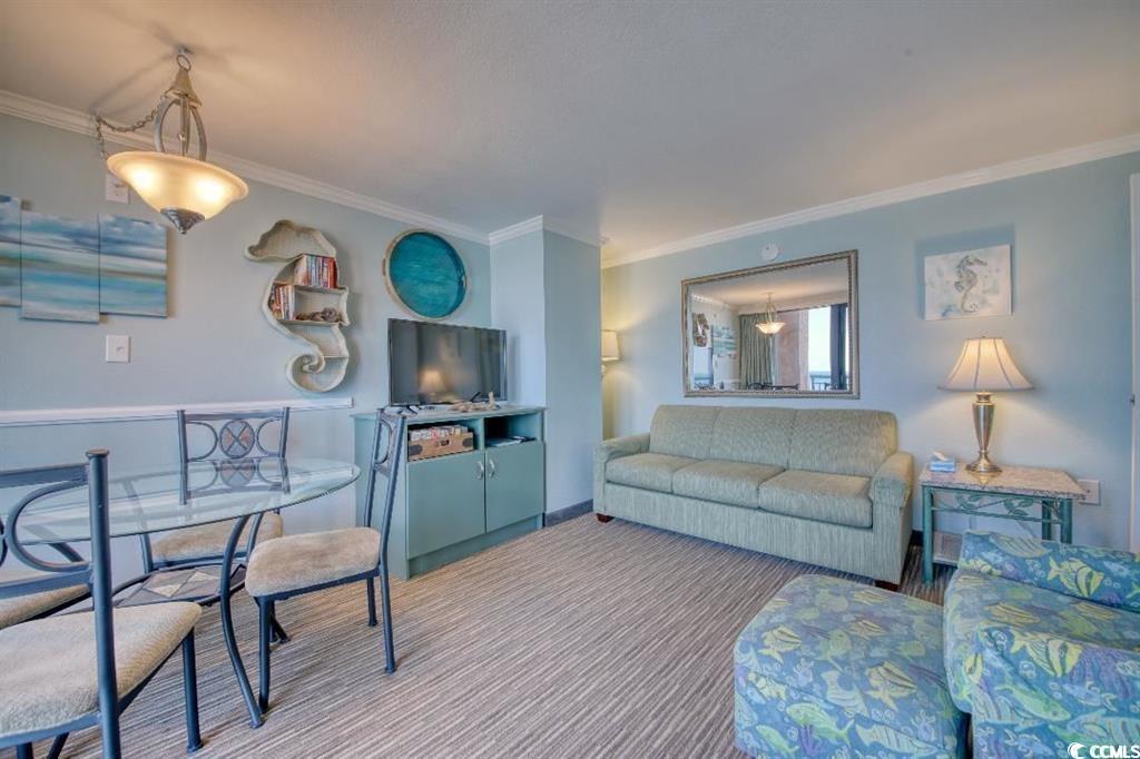 6900 North Ocean Boulevard, Unit 611 Myrtle Beach, SC 29572 - Photo 4 of 17 Carpeted living room with ornamental molding