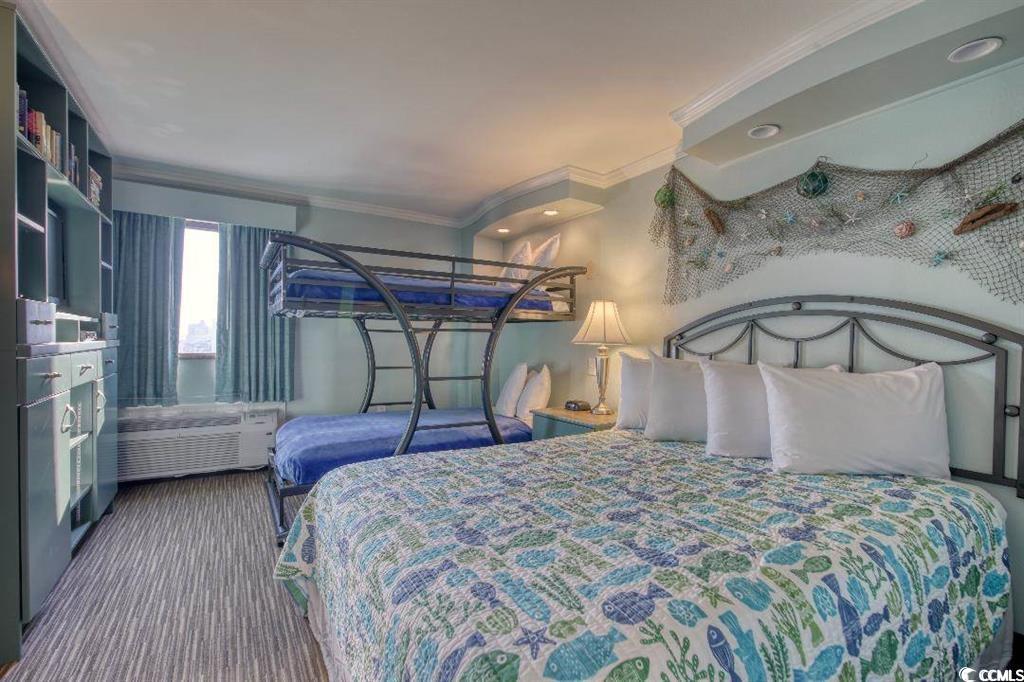 6900 North Ocean Boulevard, Unit 611 Myrtle Beach, SC 29572 - Photo 5 of 17 Bedroom with ornamental molding and dark carpet