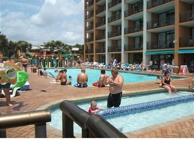 6900 North Ocean Boulevard, Unit 611 Myrtle Beach, SC 29572 - Photo 10 of 17 Community pool with a jacuzzi and a patio