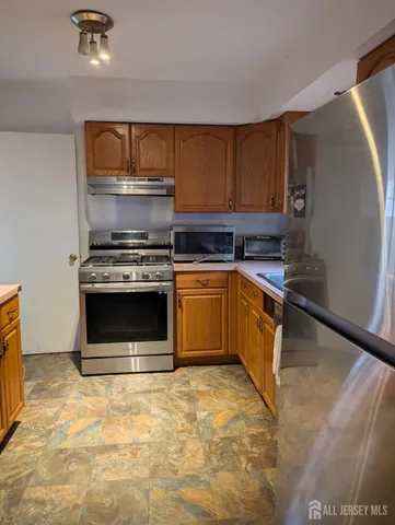 a kitchen with a stove and a refrigerator