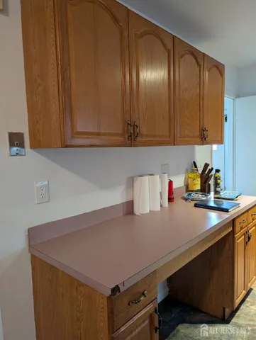 a kitchen with a sink cabinets and window