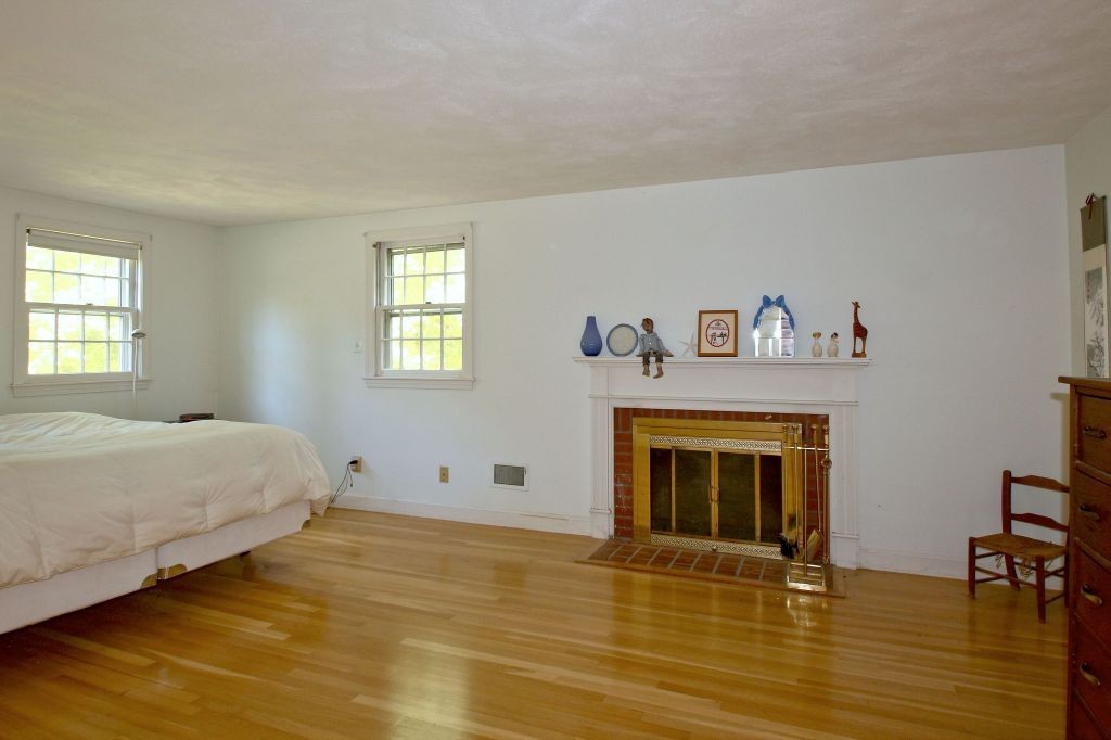 41 Campbell Road Wayland, MA 01778 - Photo 13 of 24 a bedroom with a bed and a fireplace