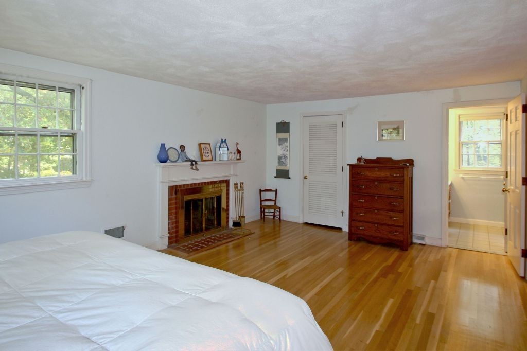 41 Campbell Road Wayland, MA 01778 - Photo 14 of 24 a spacious bedroom with a bed and a fireplace