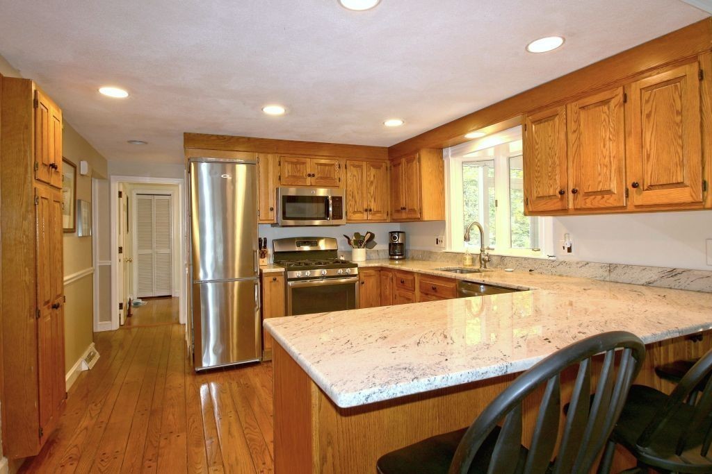 41 Campbell Road Wayland, MA 01778 - Photo 4 of 24 a kitchen with stainless steel appliances granite countertop counter space a sink and a refrigerator