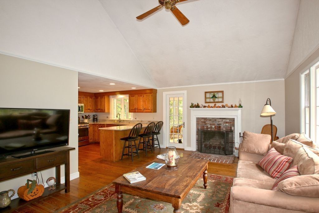 41 Campbell Road Wayland, MA 01778 - Photo 6 of 24 a living room with furniture a flat screen tv and a fireplace