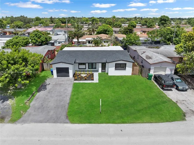 a aerial view of a house with a yard and a garage