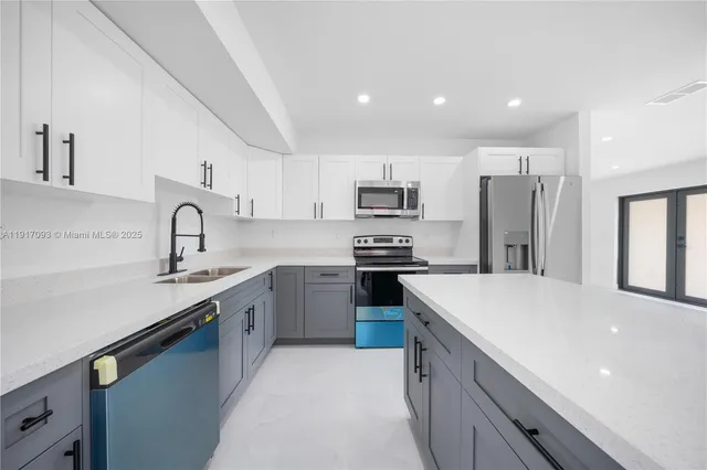a kitchen with a sink cabinets and stainless steel appliances