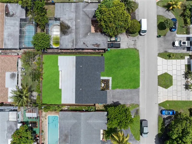 an aerial view of a house with a yard