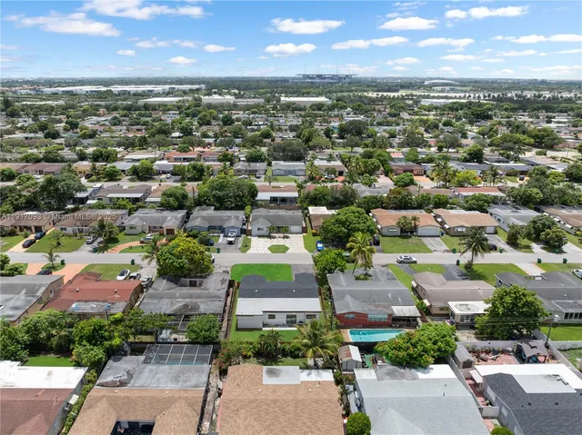 an aerial view of residential houses with outdoor space