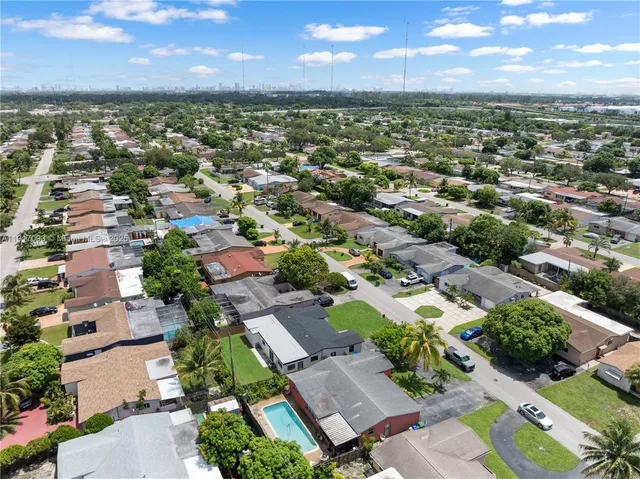 an aerial view of residential houses with outdoor space