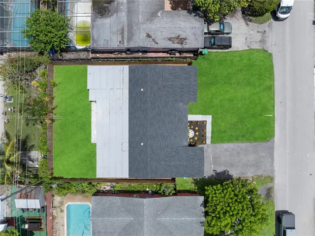 an aerial view of a house with a yard