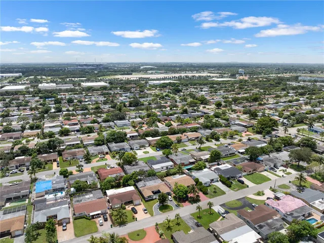 an aerial view of residential houses with city view