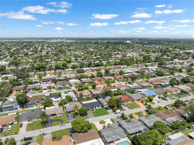 an aerial view of residential houses with city view