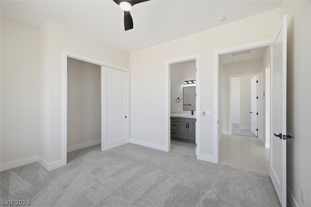 5910 East Kellogg Road Pahrump, NV 89061 - Photo 25 of 58 Plush carpeting and crisp white walls create a serene setting for slumber and relaxation.