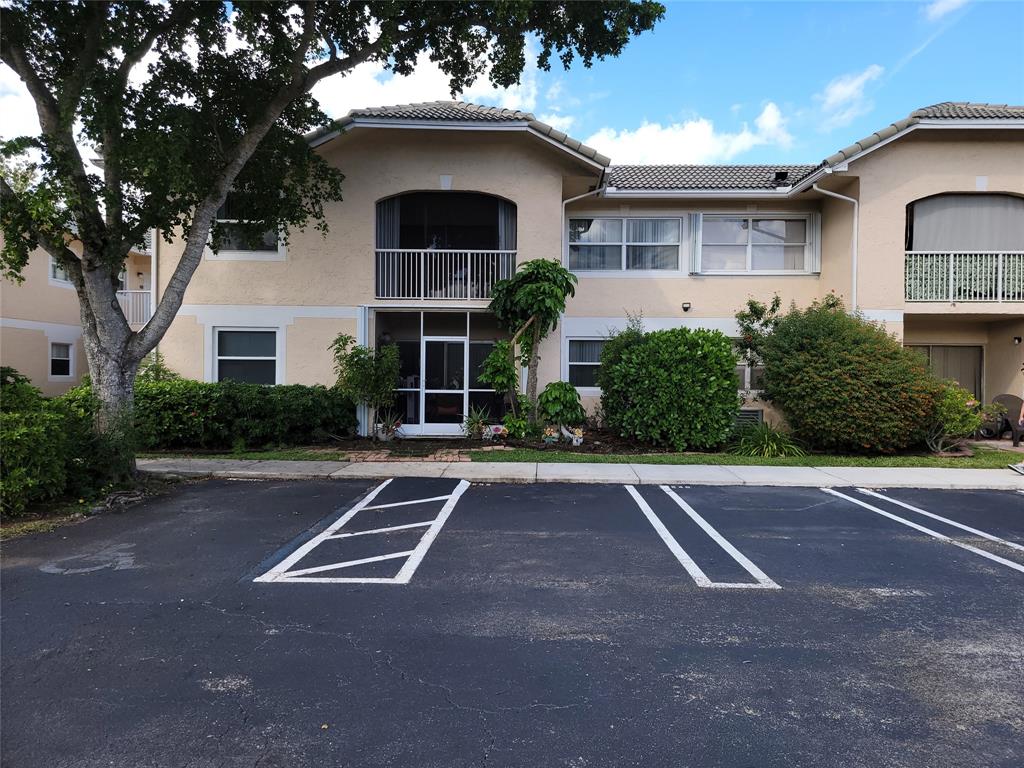 12255 Royal Palm Boulevard, Unit 8O Coral Springs, FL 33065 - Photo 1 of 15 a front view of a house with yard