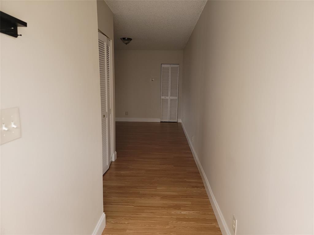 12255 Royal Palm Boulevard, Unit 8O Coral Springs, FL 33065 - Photo 12 of 15 a view of a hallway with wooden floor