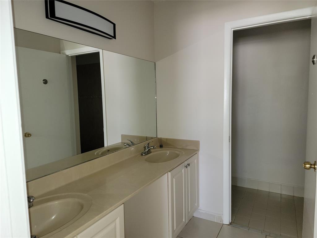 12255 Royal Palm Boulevard, Unit 8O Coral Springs, FL 33065 - Photo 13 of 15 a bathroom with a granite countertop sink and white cabinets