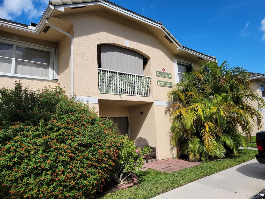 12255 Royal Palm Boulevard, Unit 8O Coral Springs, FL 33065 - Photo 2 of 15 a front view of a house with a garden