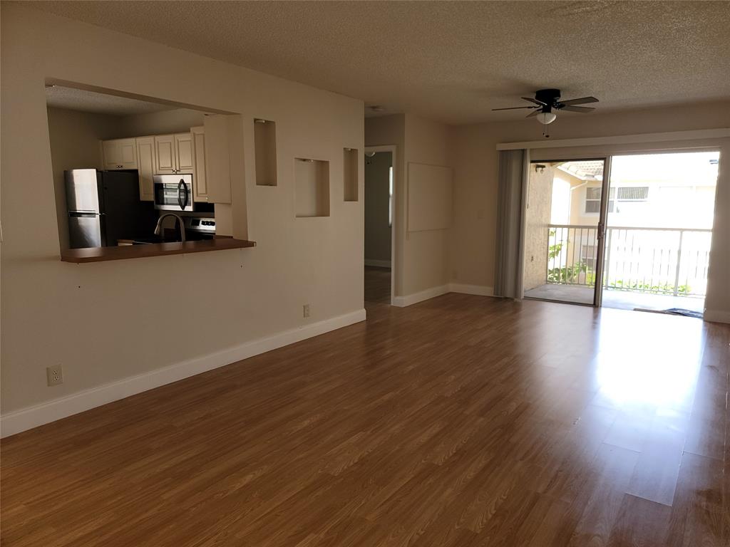 12255 Royal Palm Boulevard, Unit 8O Coral Springs, FL 33065 - Photo 5 of 15 a view of a living room a wooden floor and a window