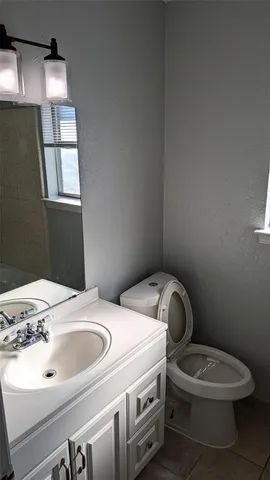 a bathroom with a sink a toilet and vanity