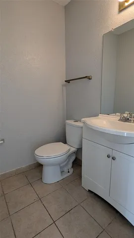 a white toilet sitting next to a bathroom sink