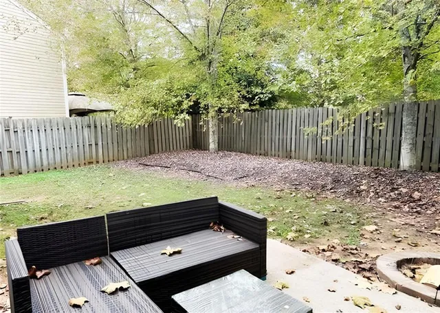 a view of a backyard with wooden fence