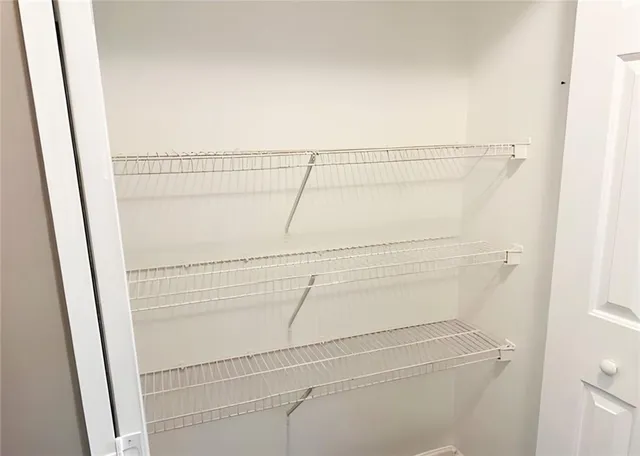 a view of storage and utility room with racks on the wall