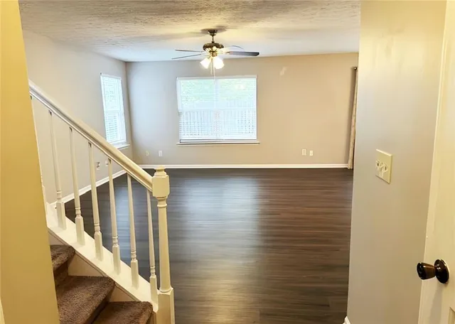 a view of entryway and hall with wooden floor