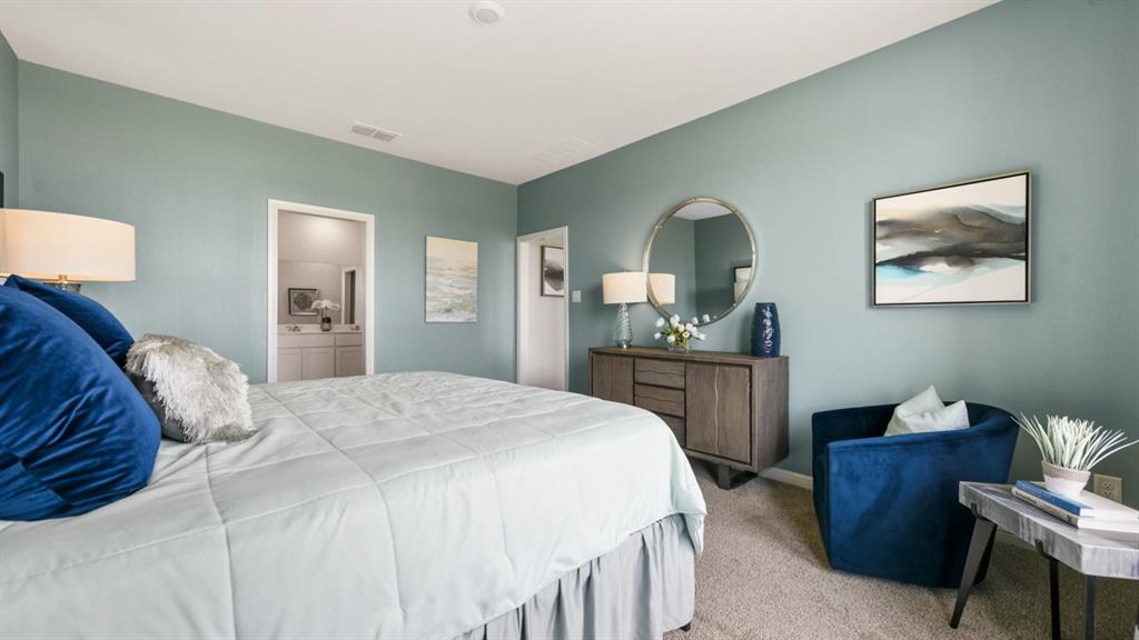 244 Kinley Street Grandview, TX 76050 - Photo 12 of 32 a spacious bedroom with a bed and a dresser