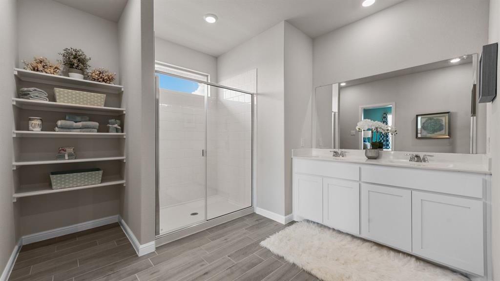 244 Kinley Street Grandview, TX 76050 - Photo 14 of 32 a bathroom with a double vanity sink and a mirror