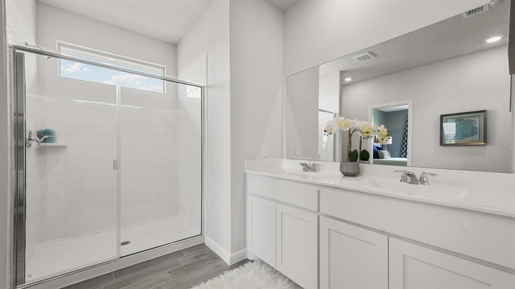244 Kinley Street Grandview, TX 76050 - Photo 15 of 32 a bathroom with a double vanity sink mirror and shower