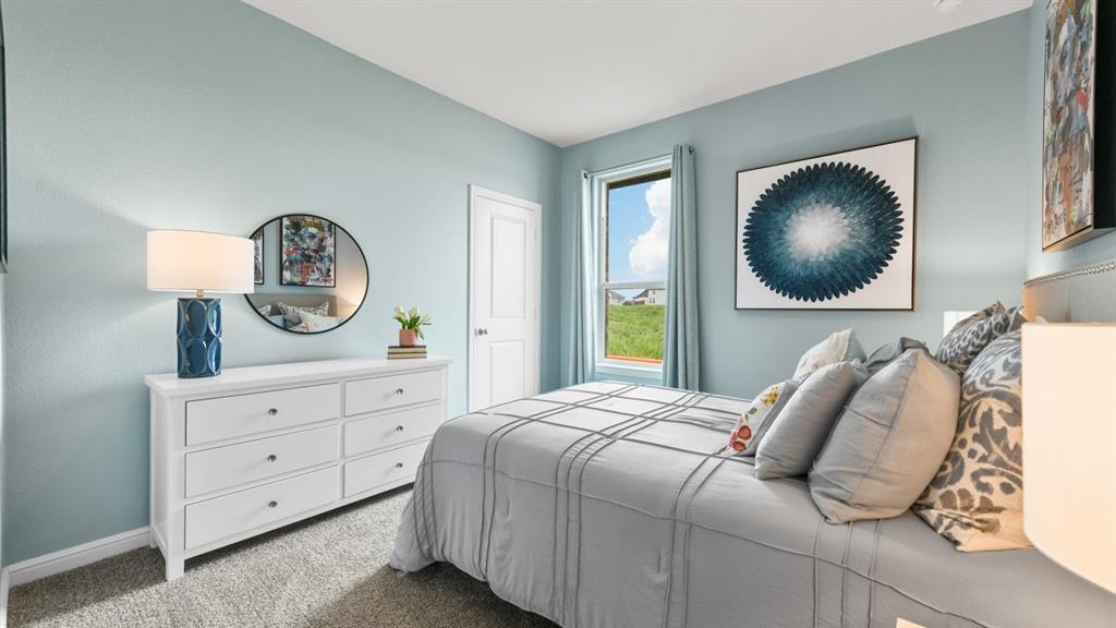 244 Kinley Street Grandview, TX 76050 - Photo 18 of 32 a bedroom with a bed a mirror on dresser and a chandelier