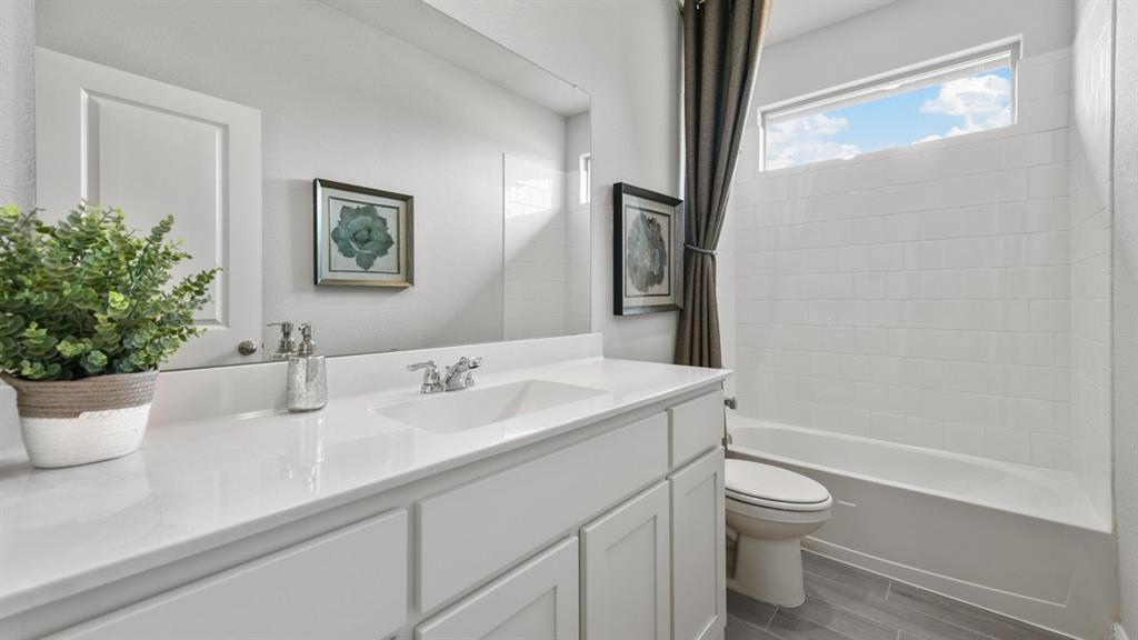 244 Kinley Street Grandview, TX 76050 - Photo 20 of 32 a bathroom with a toilet sink and mirror