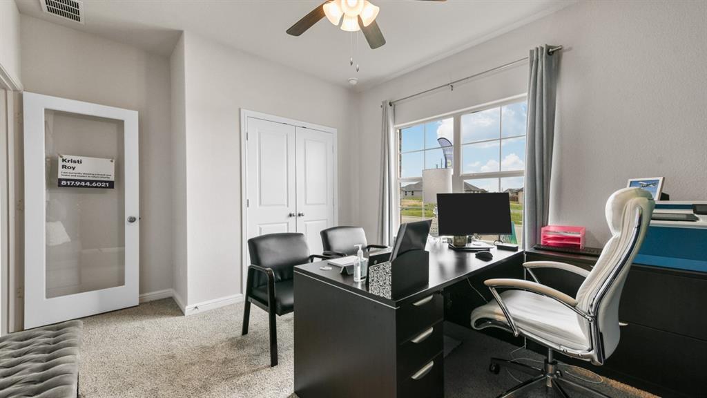 244 Kinley Street Grandview, TX 76050 - Photo 22 of 32 a work room with furniture and a chandelier