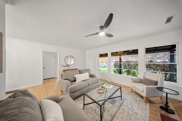 a living room with furniture and a large window