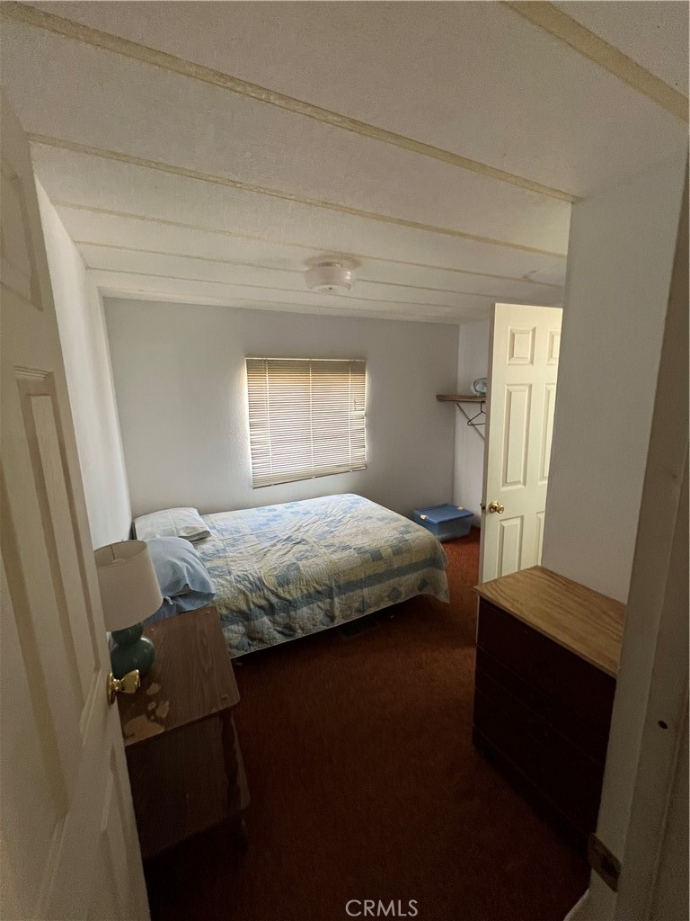 10369 Fairlane Road Lucerne Valley, CA 92356 - Photo 6 of 12 a bedroom with a bed and a window