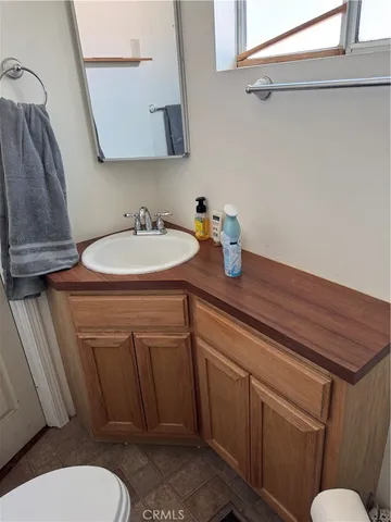 a bathroom with a sink a toilet and a mirror
