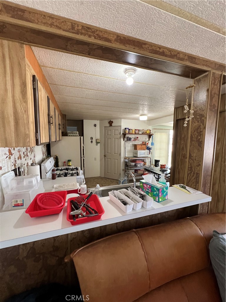 10369 Fairlane Road Lucerne Valley, CA 92356 - Photo 9 of 12 a room with furniture and a chandelier