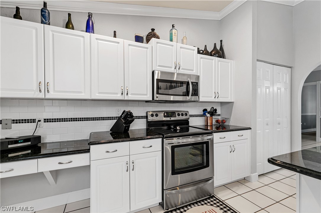 17571 Oak Creek Road Alva, FL 33920 - Photo 13 of 49 a kitchen with cabinets stainless steel appliances and sink