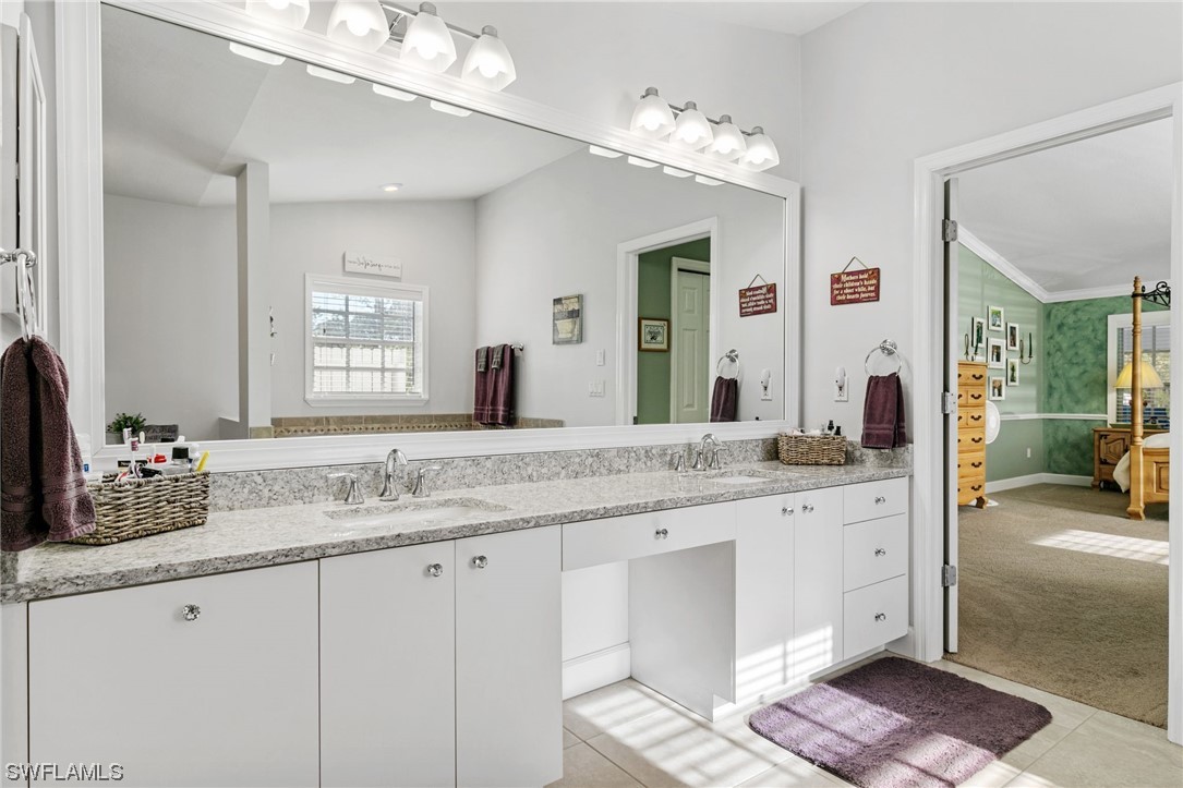 17571 Oak Creek Road Alva, FL 33920 - Photo 18 of 49 a bathroom with a granite countertop double vanity sink and a mirror