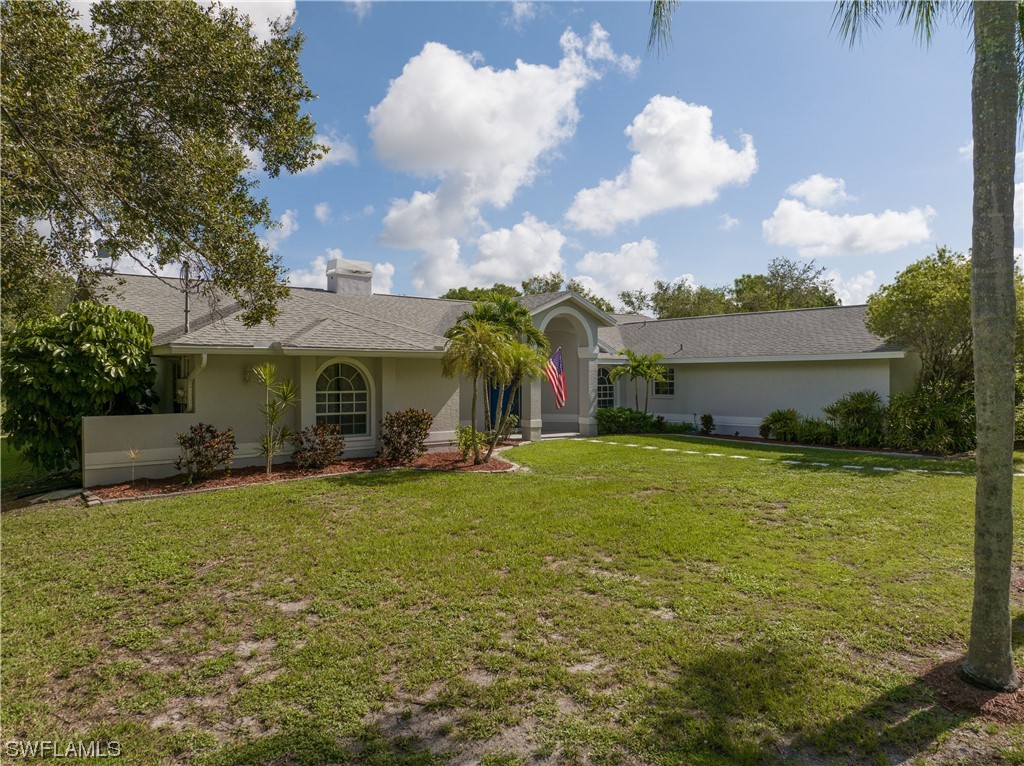 17571 Oak Creek Road Alva, FL 33920 - Photo 2 of 49 a view of a house with a yard and garage
