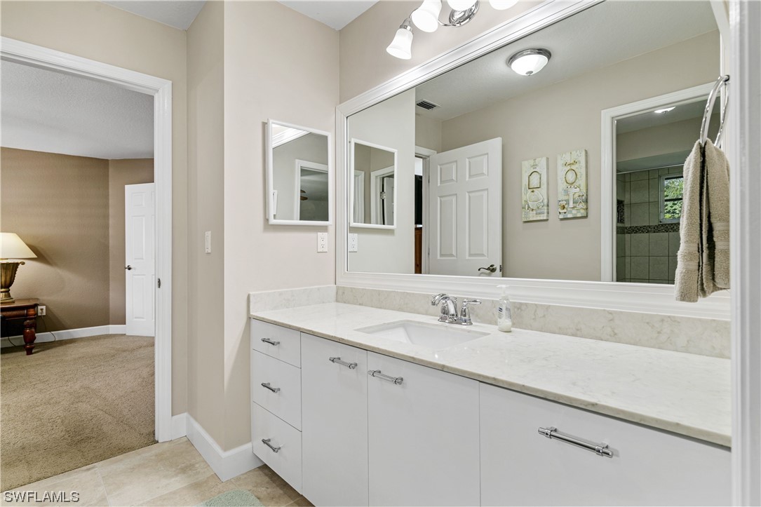 17571 Oak Creek Road Alva, FL 33920 - Photo 24 of 49 a bathroom with a sink and a mirror