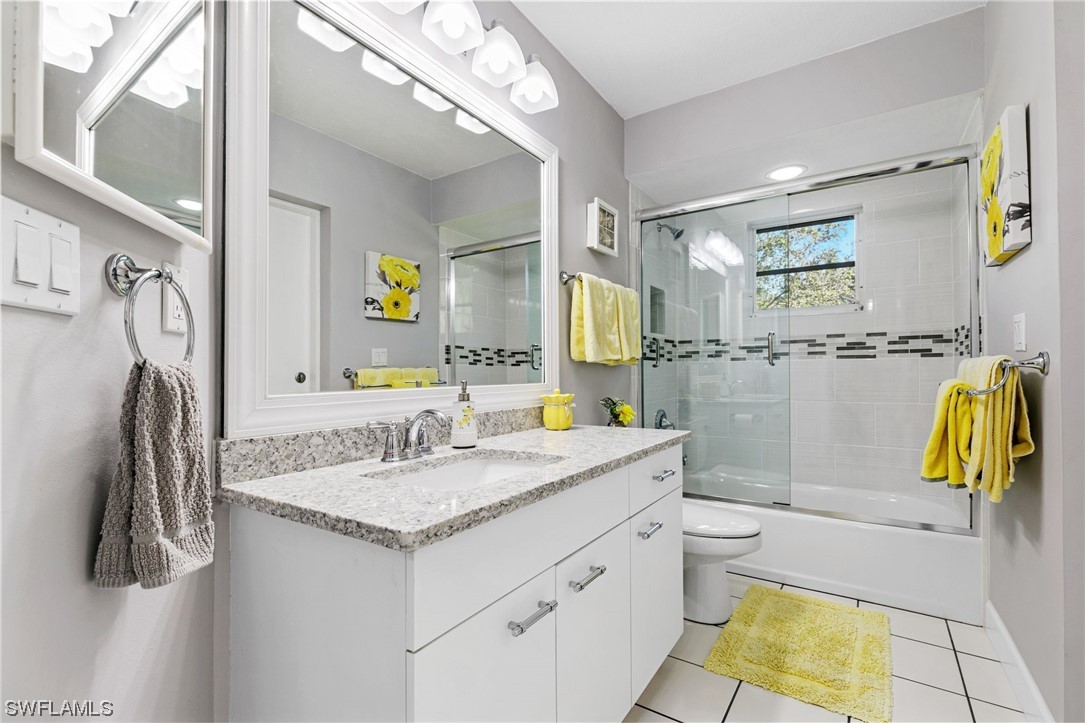 17571 Oak Creek Road Alva, FL 33920 - Photo 26 of 49 a bathroom with a granite countertop sink and a mirror
